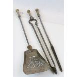 Set of antique fire irons with decorated brass handles with pummels