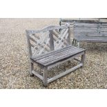 Vintage wooden garden bench with lattice work support