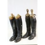 Two pairs of leather riding boots with wooden trees