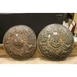 Pair of brass effect resin wall chargers decorated with medieval battle scenes