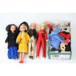 Four original Sindy dolls (condition varies) in original outfits, plus a quantity of additional