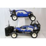 Two Thunder Tiger Pheonix remote control cars together with remote controls and accessories.