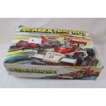 Boxed Scalextric GP1 C529 with 2 x slot cars (damaged box)