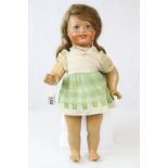 Composition doll with wig and flirty eyes looking to the side circa 1900s in gd condition