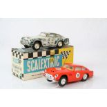 Boxed Triang Scalextric E3 Aston Martin GT slot car with lights in green (showing wear to shell) and