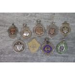 Nine silver fob medallions to include blank cartouches, enamelled Western Time Trials fob, Bagatelle