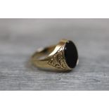 Onyx 9ct yellow gold signet ring, plain polished oval faceted onyx, rub over setting, scroll