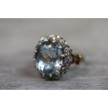 Topaz and cubic zirconia 9ct yellow gold cluster ring, the large central oval mixed cut topaz