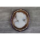 Victorian enamelled and pearl set carnelian cameo yellow metal brooch, the cameo depicting Grecian