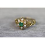 Emerald and seed pearl 9ct yellow gold flower head ring, round mixed cut emerald to centre, diameter