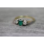 Emerald and diamond three stone 18ct yellow gold platinum set , the central rectangular cut