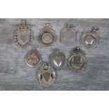 Eight silver fob medallions comprising five with blank cartouches, a parcel gilt skittles medallion,