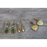 Pair of peridot and pearl yellow metal drop earrings; pair of horn shell shaped yellow metal drop