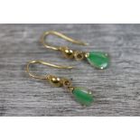 Pair of jade yellow metal drop earrings, comprising a pear shaped cabochon cut jade, dimensions