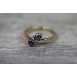 Sapphire and diamond 18ct yellow gold ring, comprising two cornflower blue round mixed cut