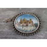 Hand painted unmarked silver Cannetille brooch, the oval hand painted panel depicting a gilt