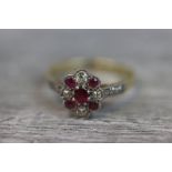 Red spinel and diamond 18ct yellow gold platinum set cluster ring, the central oval mixed cut spinel