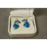 A pair of silver and enamel set heart shaped earrings