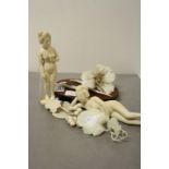 Two 19th Century Japanese carved Ivory nude Females, one lying down the other holding a Flower &