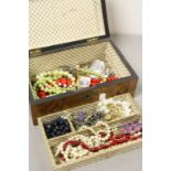 Wooden box of mixed vintage Costume jewellery to include necklaces, brooches etc