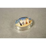 A silver pill box with enamel lid depicting cats