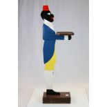 Carved wooden dumb waiter in the form of a black man wearing a fez and bow tie