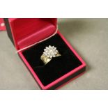 A 14ct yellow gold diamond flower head style ring, over 1ct