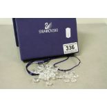 Two Swarovski Crystal Snowflakes, the larger one with 2004 tag and approx 7cm diameter with a