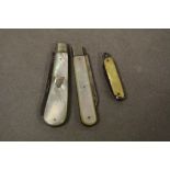 Two mother of pearl and silver fruit knives and a miniature pocket knife