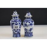 Pair of Chinese blue and white lidded vases decorated with fish, urns, dogs of foe finial's to lids,