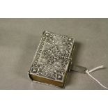 An antique white metal casket in the form of a bible box .