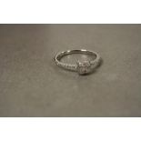 An 18ct white gold diamond ring central princess cut with diamond shoulders