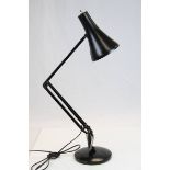 A 20th century anglepoise lamp .