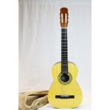 A cased Clasico Spanish acoustic guitar.
