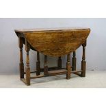 Oak Gate-leg Table raised on Turned Baluster and Block Supports, 107cms wide x 73cms high
