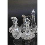 A cut glass wine claret jug and four similar decanters.