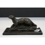 A signed bronzed spelter figure of an otter raised on a plinth base