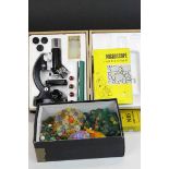 Boxed microscope, microscope slides and books, together with a quantity of marbles