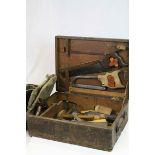 Wooden toolbox containing vintage tools to include, saws, wood planes, measures etc