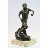 A bronzed spelter figure of a footballer