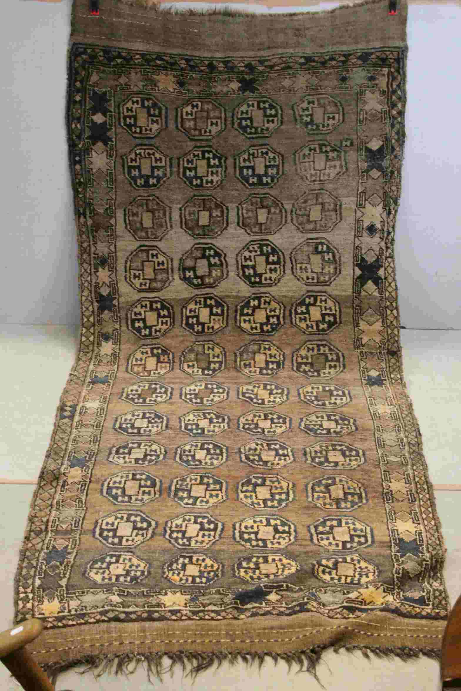 19thcentury Afghan Nomad Rug with old label to reverse, 295cms x 123cms
