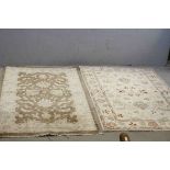 Two Cream Ground Rugs, 147cms x 92cms and 150cms x 102cms