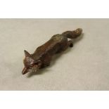 An antique cold painted bronze of a fox impressed no to leg.