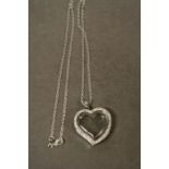 A silver and CZ glass heart shaped locket on silver chain