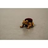 A brass cased frog pincushion