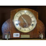 Art Deco period mantle clock with stylised inlaid decoration to the case, previous owner inscription