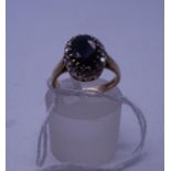 Oval sapphire and diamond ring, oval sapphire to the centre surrounded by small diamonds, size L