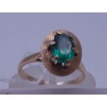 9ct gold emerald ring, the top set with a small claw set emerald