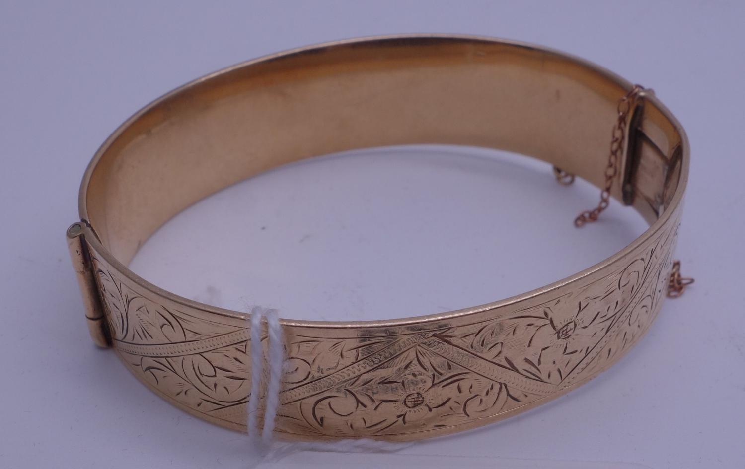 Gold coloured bangle marked to the interior 9ct gold with metal core