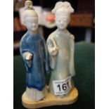 2 x glazed Ming style figures, one in a blue coat and one in a green coat, 6.1/4" tall, damage to